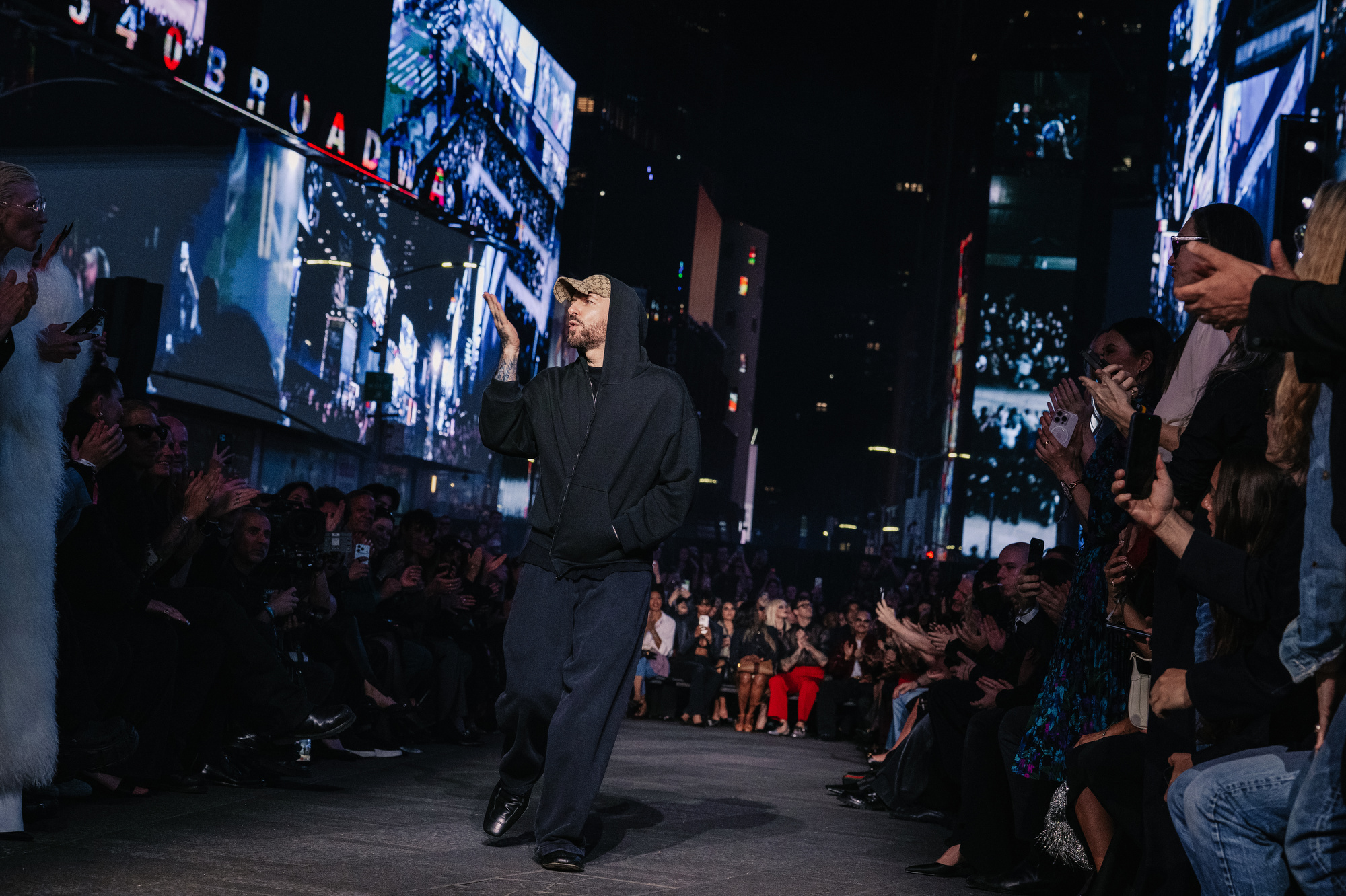 Gucci Cruise 2027 — Cindy Crawford in feather-sprigged gown closing the show, Times Square.