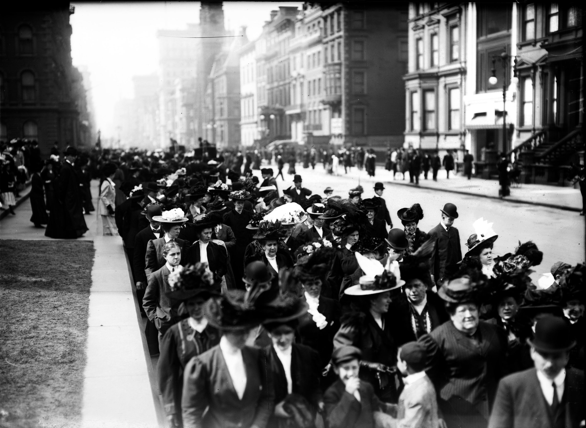 Crowds in their Easter hats filling the sidewalk of Fifth Avenue.