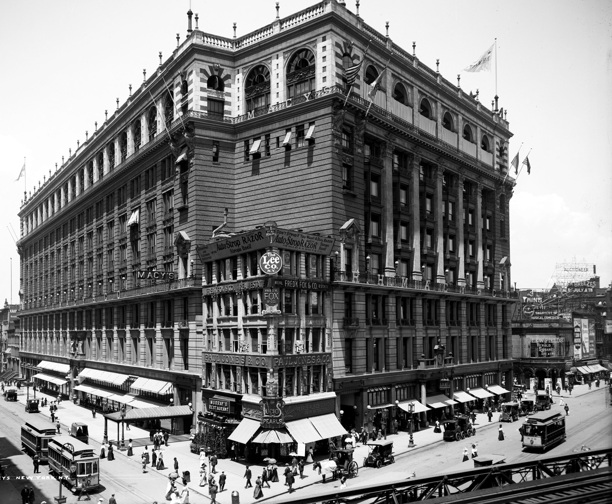 The Macy’s building at Herald Square, its awnings, signs and street traffic.